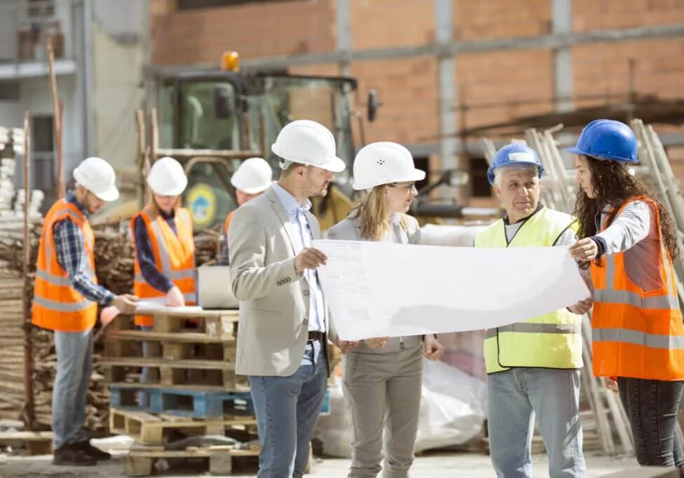 Construction workers talking on site