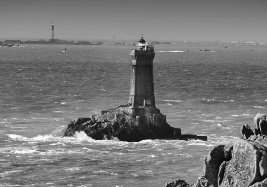Famous lighthouses in a stormy day full with fog and wild wind, PointeDuRaz, Brittany, France