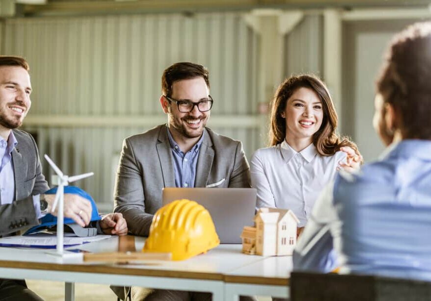 Group of happy building contractors having a job interview with a candidate in the office.