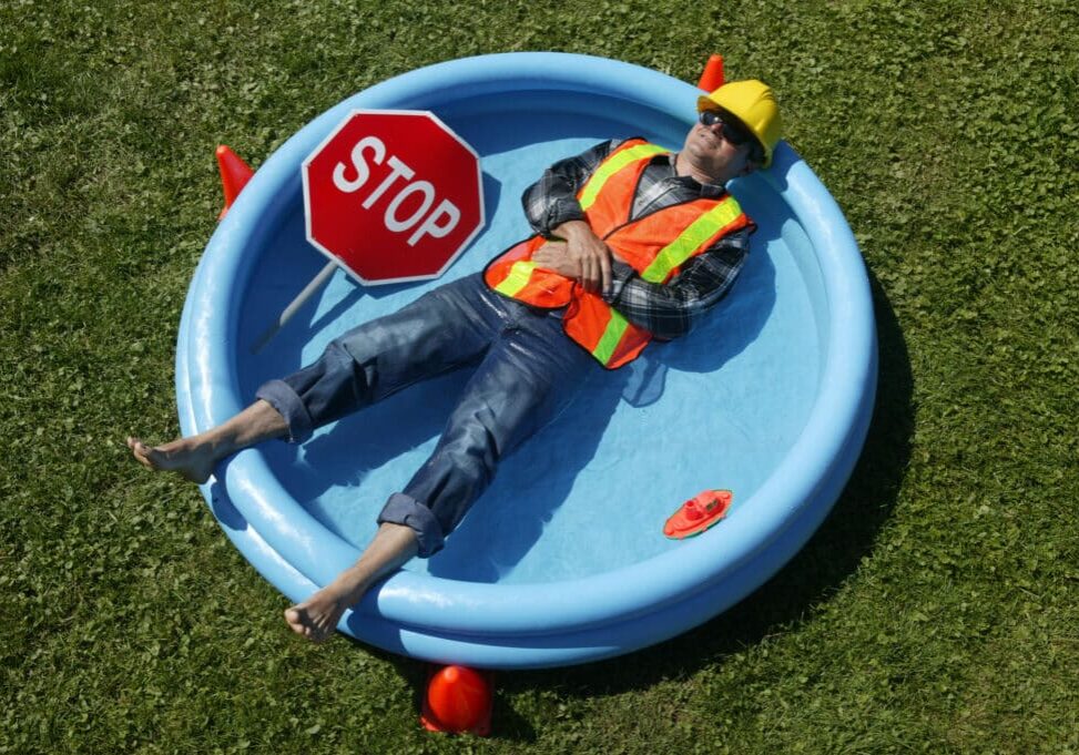 construction worker lying down in a swimming pool