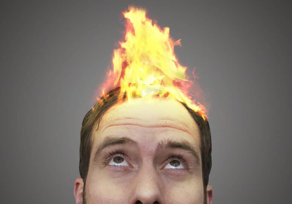 Surreal photo of a fire spreading on a man's head.