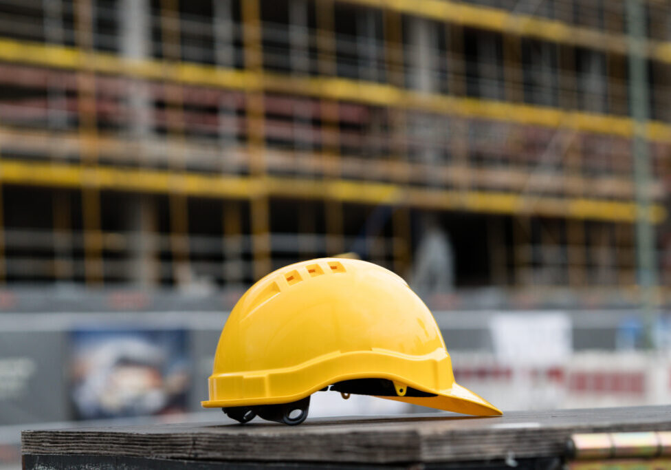 Yellow safety hardhat. Side view